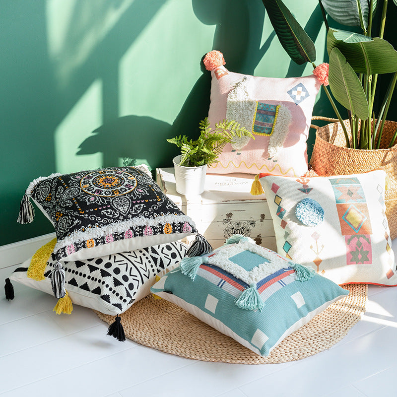Square cushion cover with 3D alpaca appliqué, bouclé patch and pom-pom corners