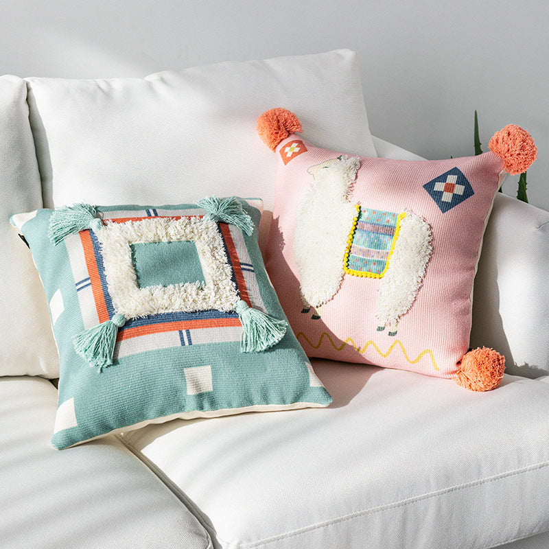 Square cushion cover with 3D alpaca appliqué, bouclé patch and pom-pom corners