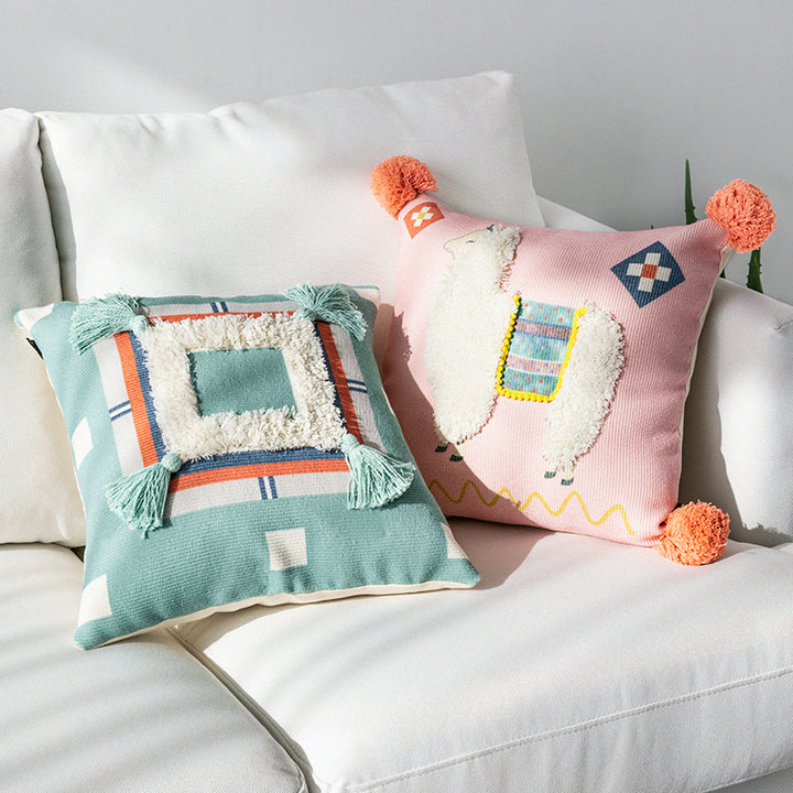 Square cushion cover with 3D alpaca appliqué, bouclé patch and pom-pom corners