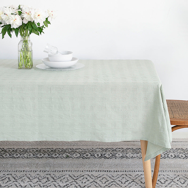 Tablecloth made of cotton blend with embossed square and circle relief