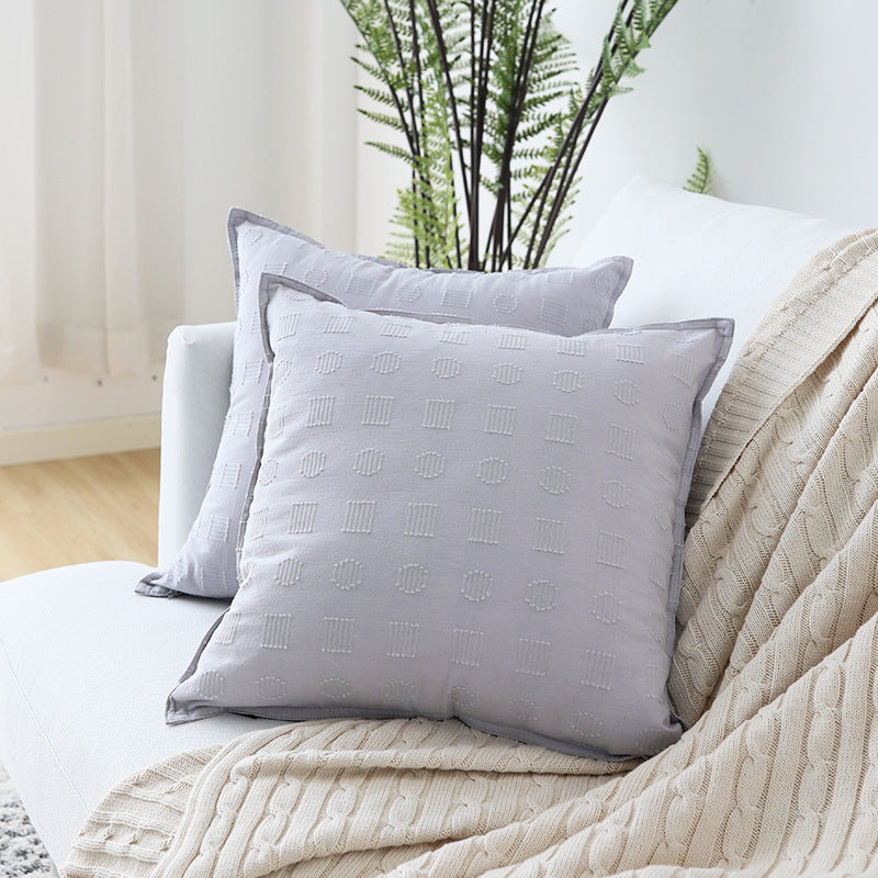 Square decorative cushion cover with subtle tufted geometric relief and piping