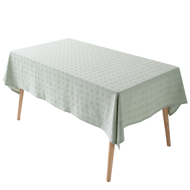 Tablecloth made of cotton blend with embossed square and circle relief