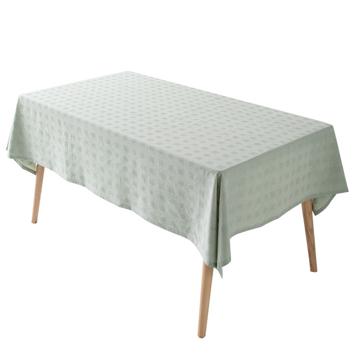 Tablecloth made of cotton blend with embossed square and circle relief