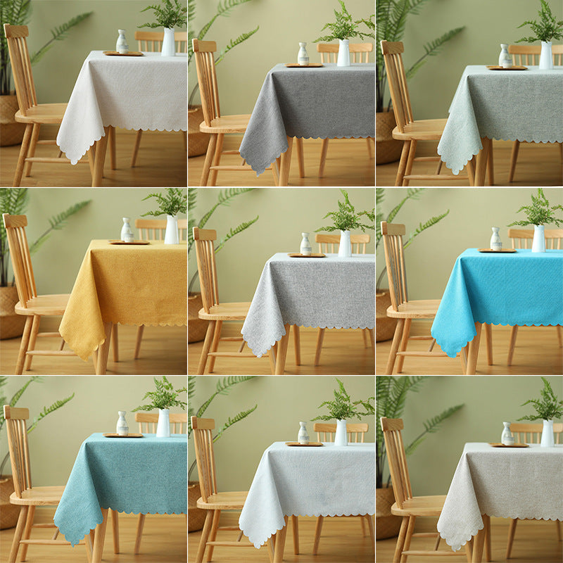 Tablecloth made of cotton blend with wavy hem and textured surface