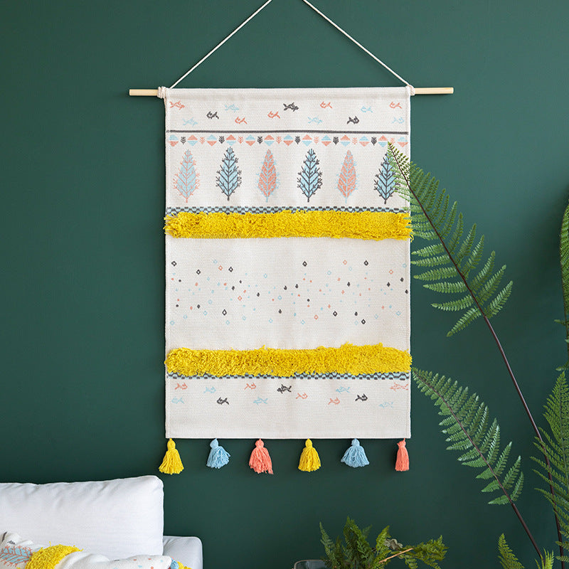 Wall tapestry in Scandi-Boho style with tufting stripes, tassels, and wooden rod