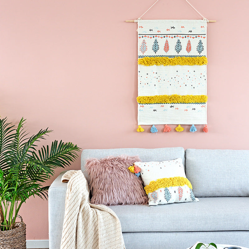 Wall tapestry in Scandi-Boho style with tufting stripes, tassels, and wooden rod