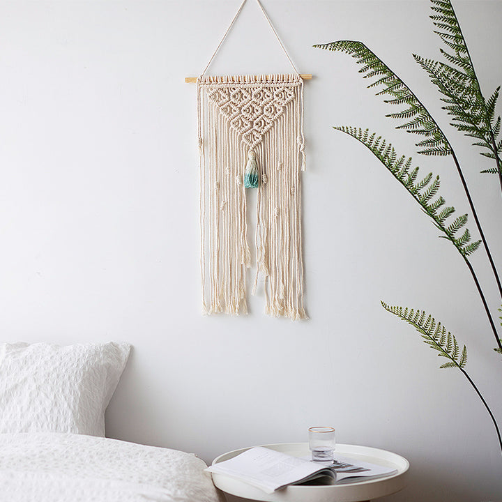 Macramé wall hanging with geometric triple tassel design and wooden rod
