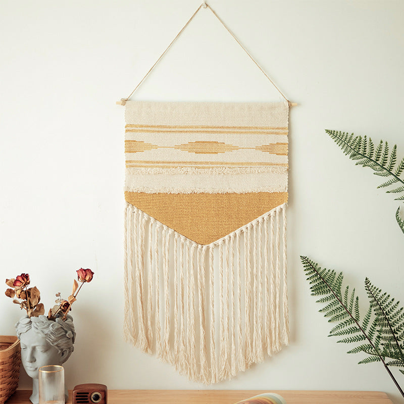 Handwoven wall hanging made of cotton blend with layered textures, wood rod and long fringes