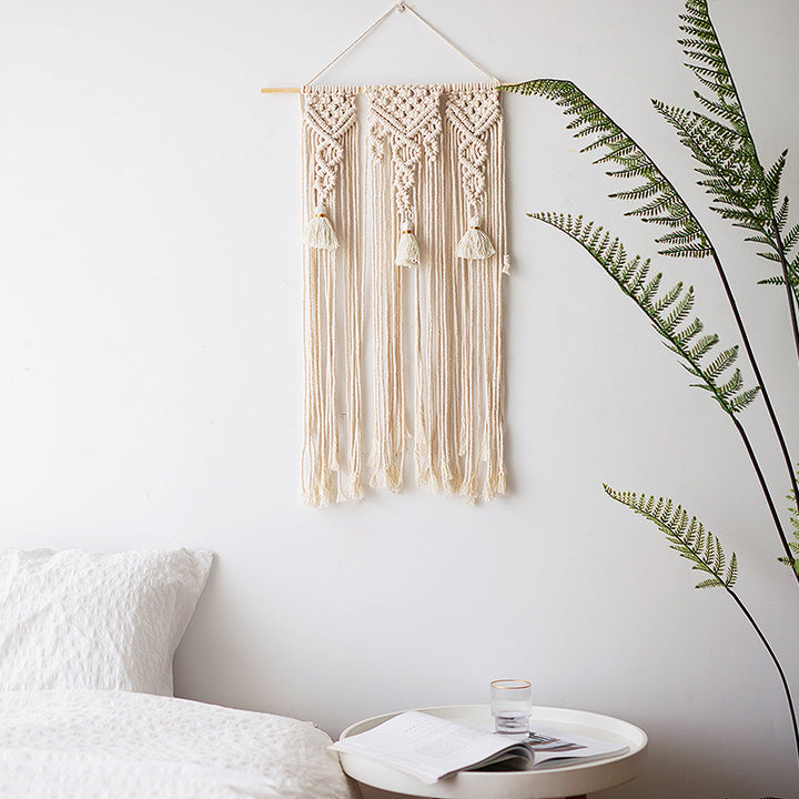 Macramé wall hanging with geometric triple tassel design and wooden rod