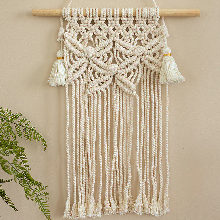 Macramé wall hanging with geometric triple tassel design and wooden rod