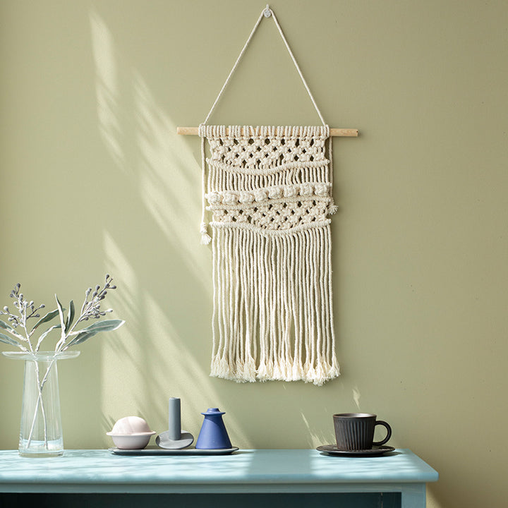 Macramé wall hanging with geometric triple tassel design and wooden rod