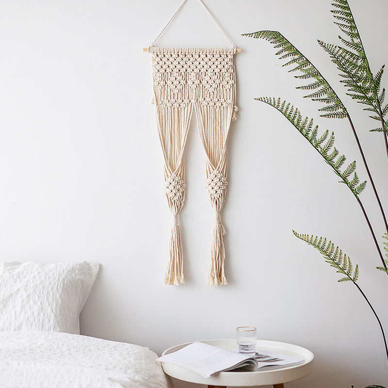 Macramé wall hanging with geometric triple tassel design and wooden rod