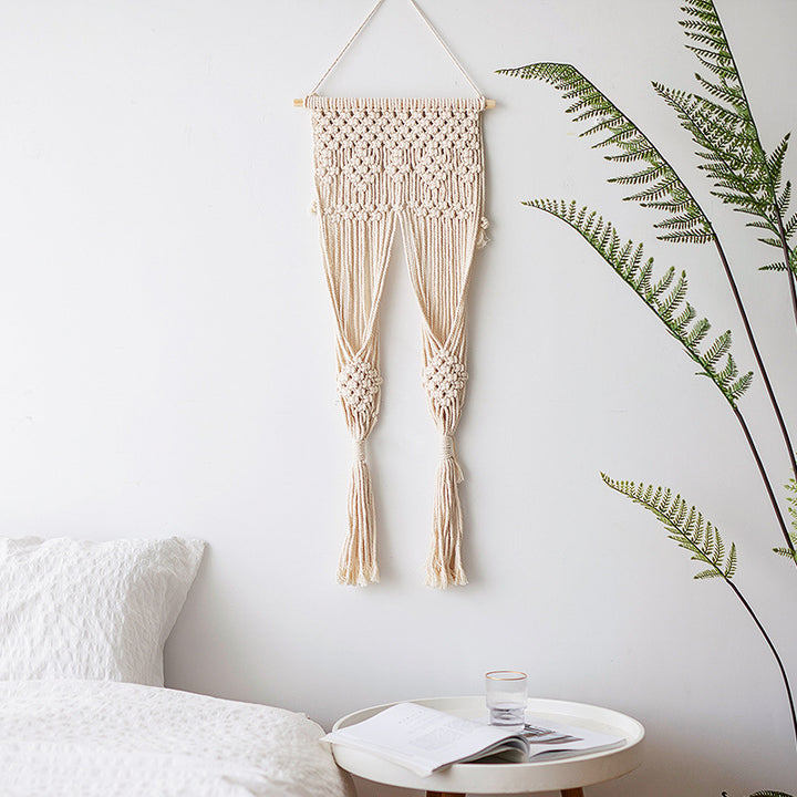 Macramé wall hanging with geometric triple tassel design and wooden rod