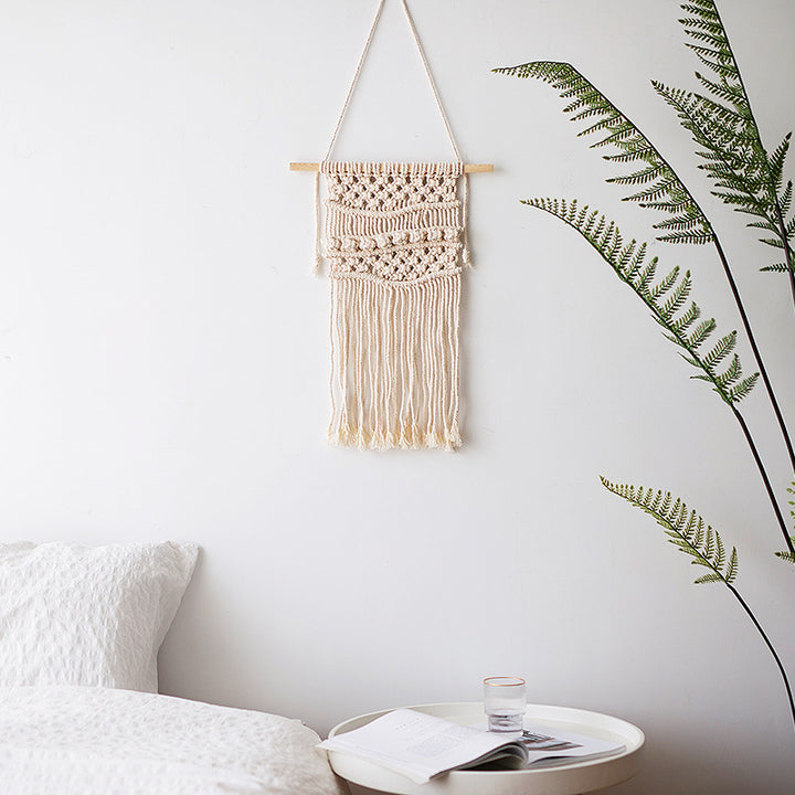 Macramé wall hanging with geometric triple tassel design and wooden rod
