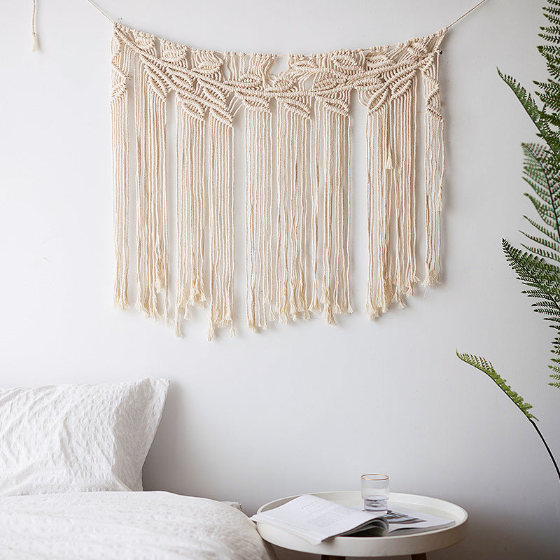 Macramé wall hanging with geometric triple tassel design and wooden rod