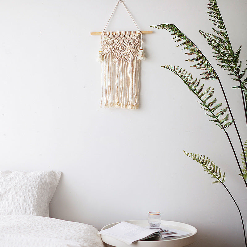 Macramé wall hanging with geometric triple tassel design and wooden rod