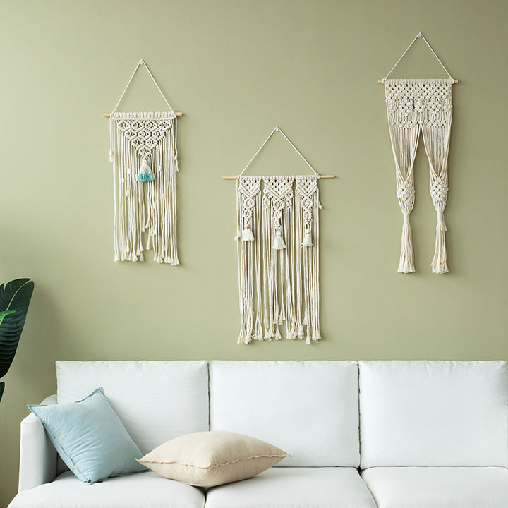 Macramé wall hanging with geometric triple tassel design and wooden rod