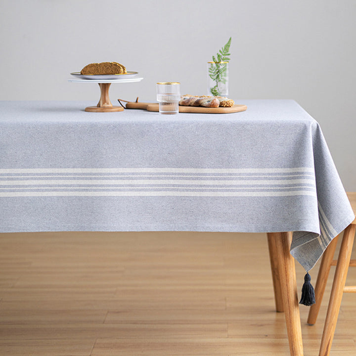 Rectangular linen look tablecloth with fringed tassels and side stripe border design