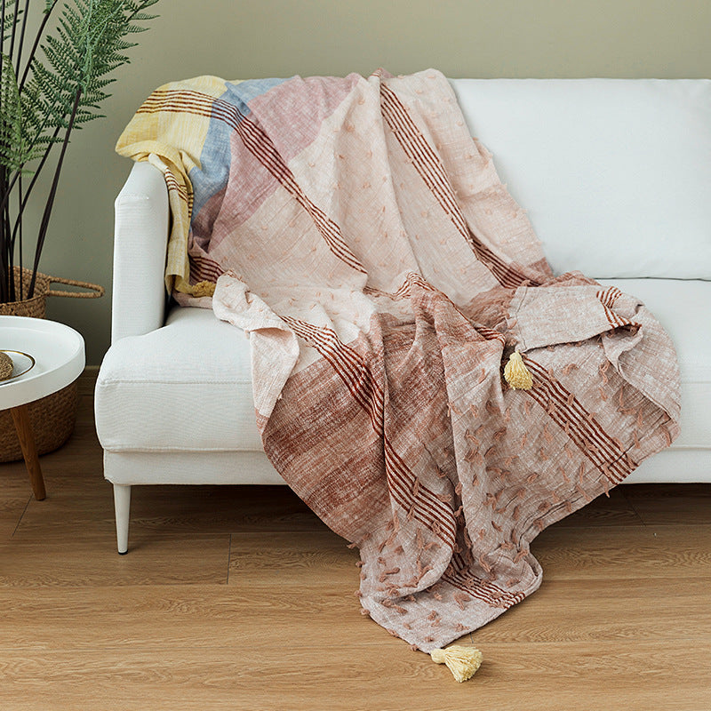 Light striped cotton throw blanket with fringes and textured knot appliqué