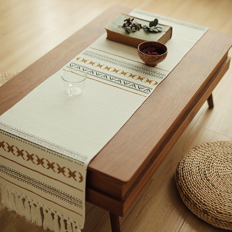 Woven Boho table runner made of cotton blend with decorative fringes and graphic stripe pattern