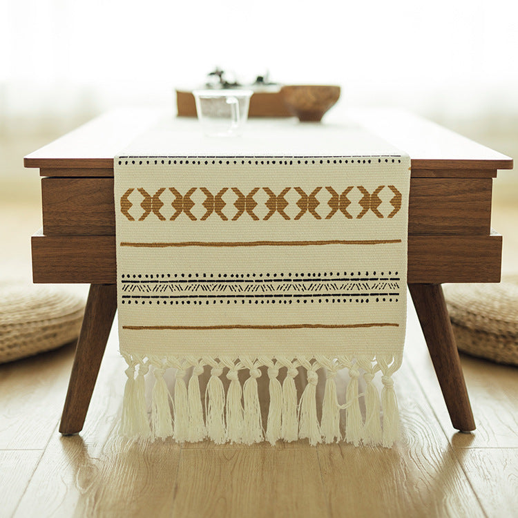 Woven Boho table runner made of cotton blend with decorative fringes and graphic stripe pattern