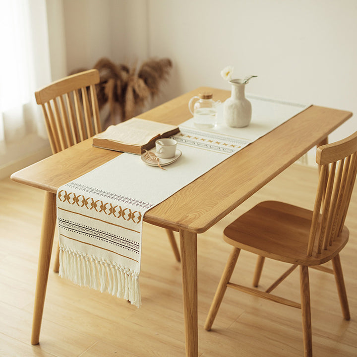 Woven Boho table runner made of cotton blend with decorative fringes and graphic stripe pattern