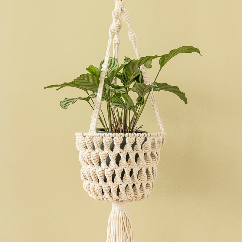 Macrame plant hanger made of cotton rope with tassels and adjustable suspension