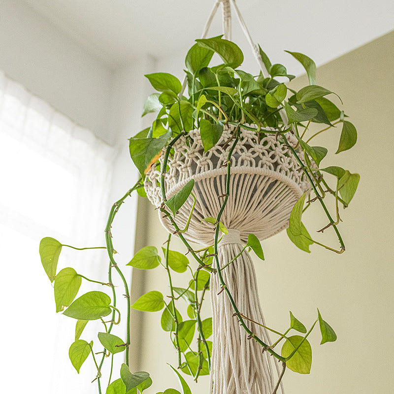 Macrame plant hanger made of cotton rope with tassels and adjustable suspension