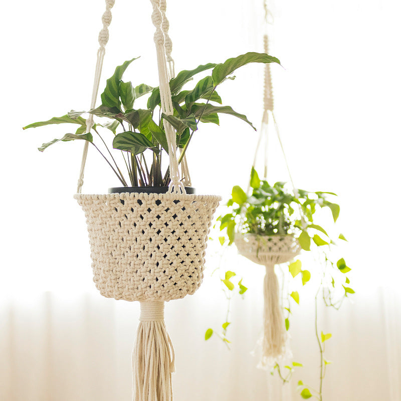 Macrame plant hanger made of cotton rope with tassels and adjustable suspension