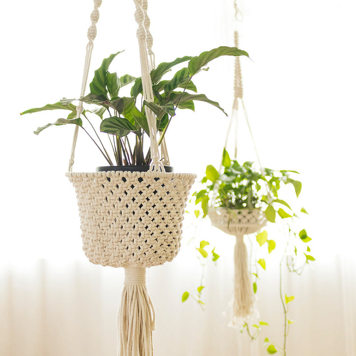 Macrame plant hanger made of cotton rope with tassels and adjustable suspension