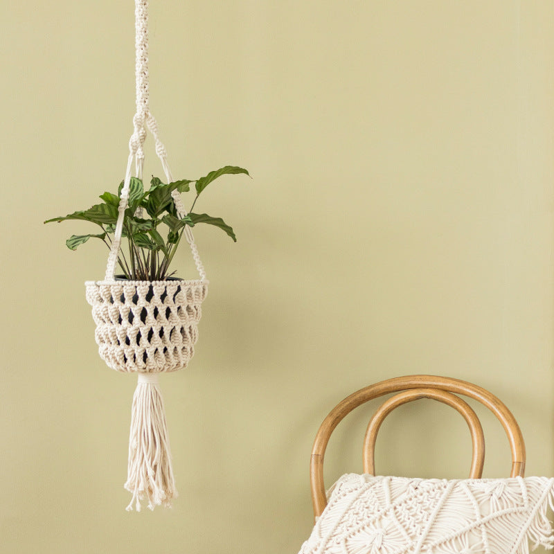 Macrame plant hanger made of cotton rope with tassels and adjustable suspension