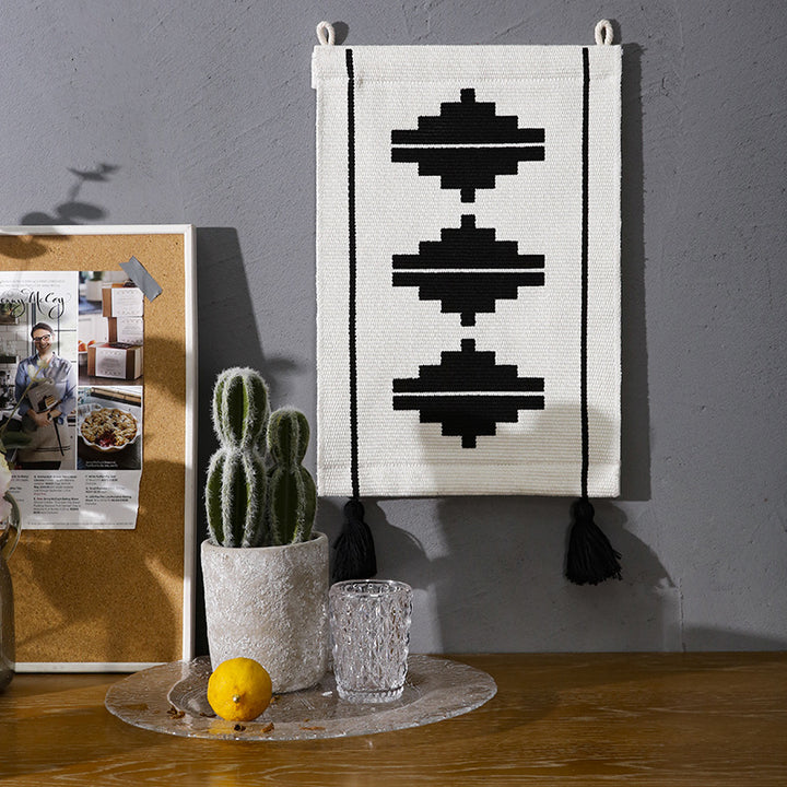 Woven wall hanging with graphic ethnic relief and tassels