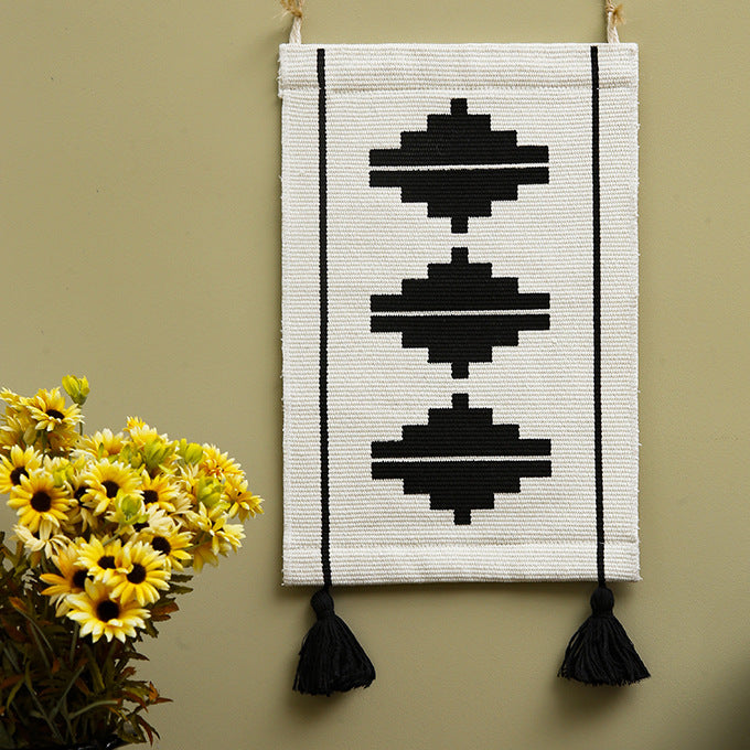 Woven wall hanging with graphic ethnic relief and tassels