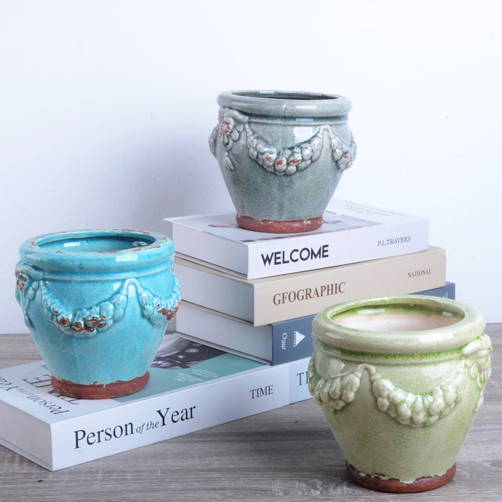 Decorative plant pot with artistic relief