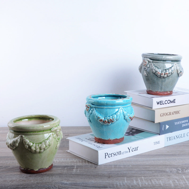 Decorative plant pot with artistic relief