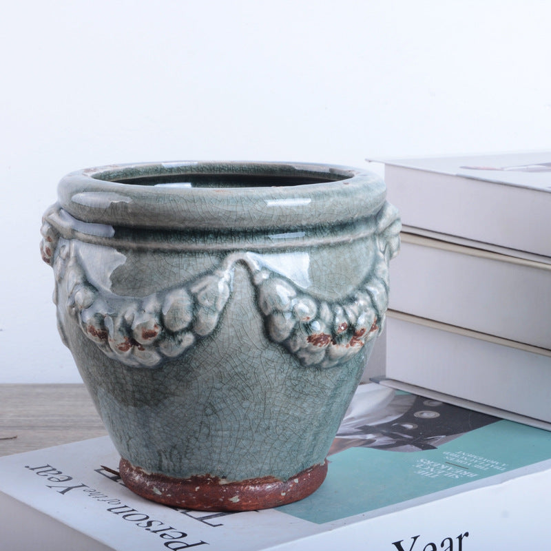Decorative plant pot with artistic relief