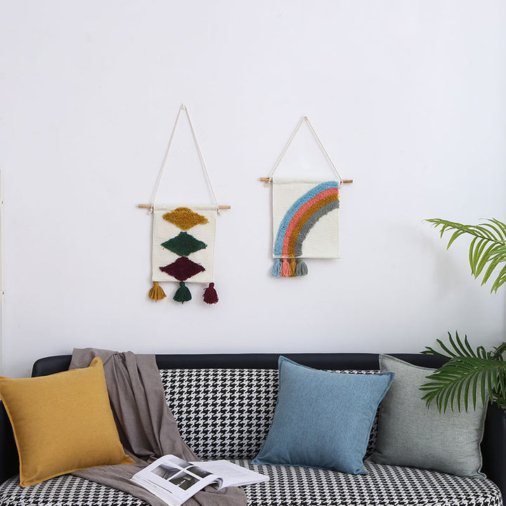 Woven wall hanging with hand-tufted rainbow design, cotton blend and decorative tassels