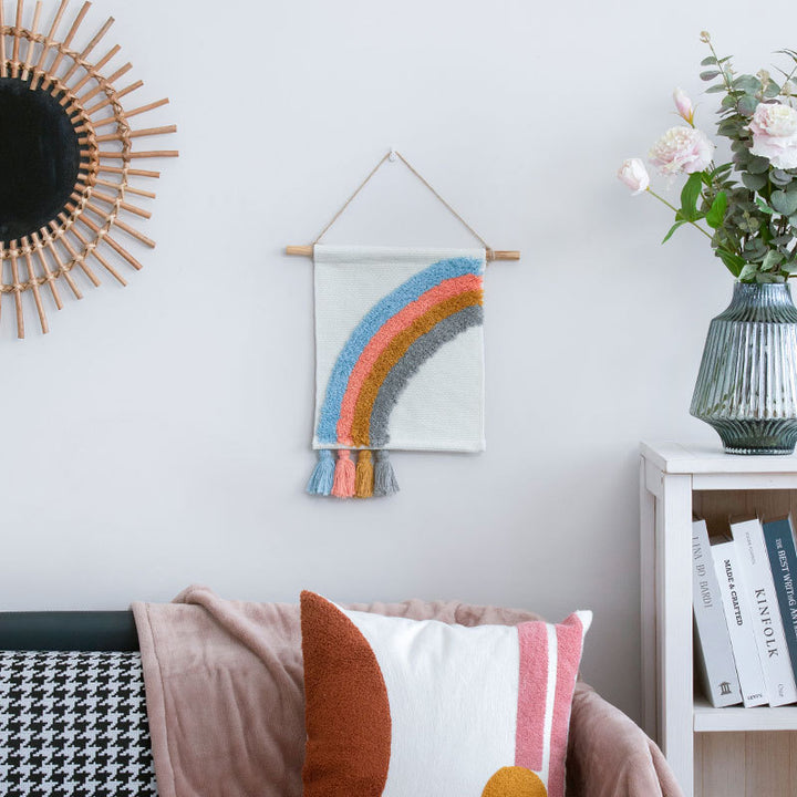 Woven wall hanging with hand-tufted rainbow design, cotton blend and decorative tassels