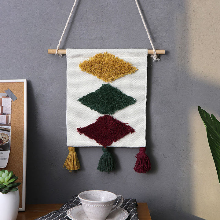 Woven wall hanging with hand-tufted rainbow design, cotton blend and decorative tassels