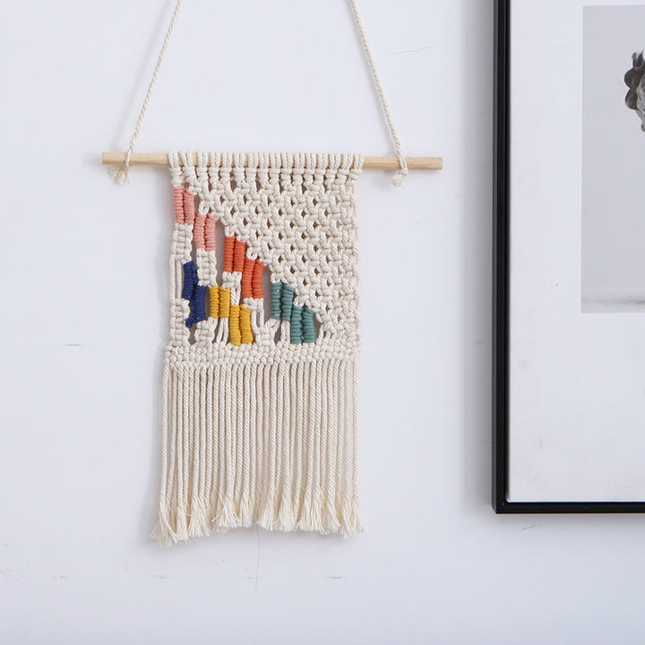Handcrafted macrame wall hanging with colorful cotton fringes and wooden rod