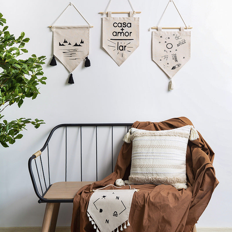 Decorative cotton wall hanging in pennant style with tassels and minimalist prints