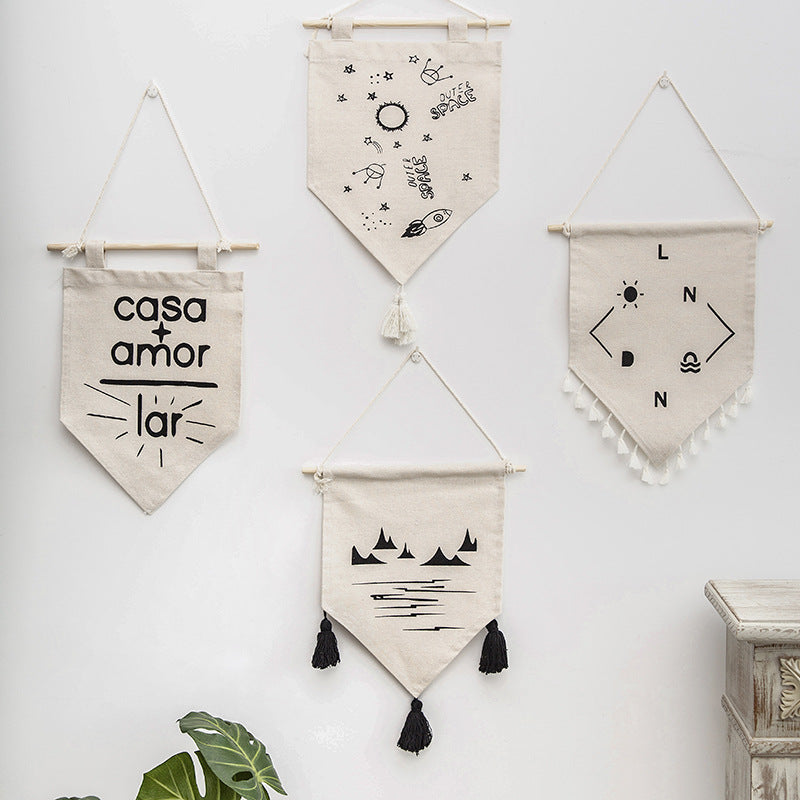 Decorative cotton wall hanging in pennant style with tassels and minimalist prints
