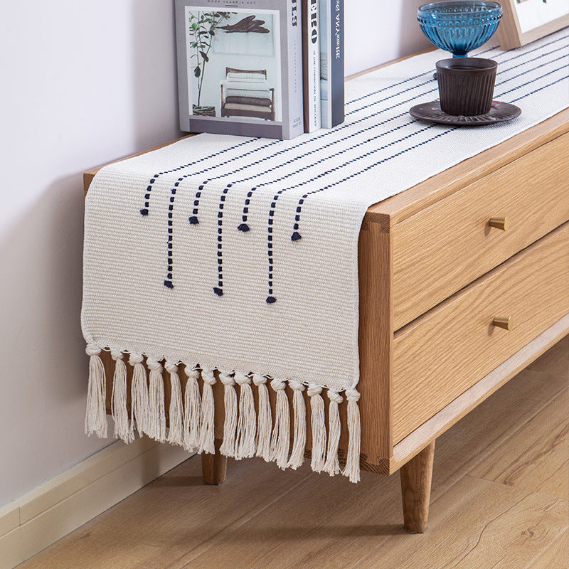 Decorative table runner in Scandinavian-minimalist design with macrame fringes