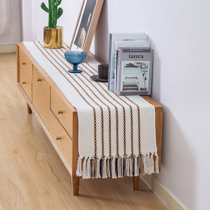 Decorative table runner in Scandinavian-minimalist design with macrame fringes