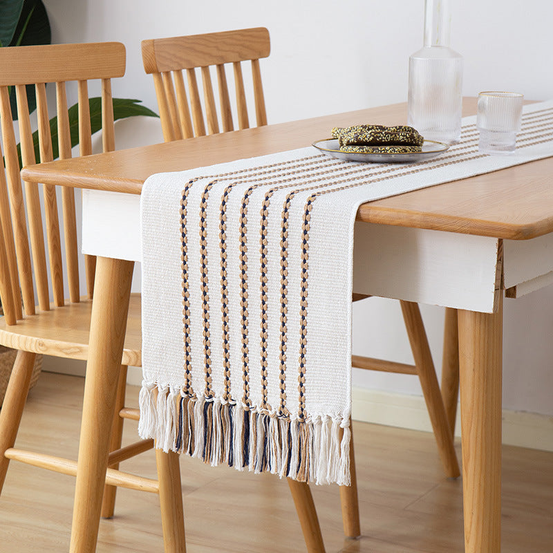 Decorative table runner in Scandinavian-minimalist design with macrame fringes