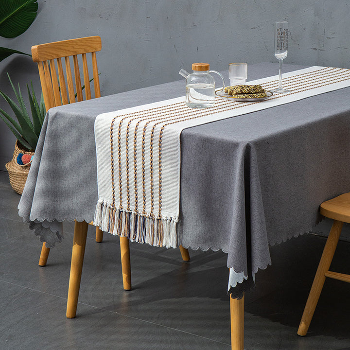 Decorative table runner in Scandinavian-minimalist design with macrame fringes