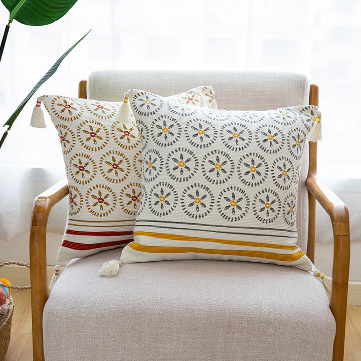 Decorative cushion cover with woven medallion pattern and tassels