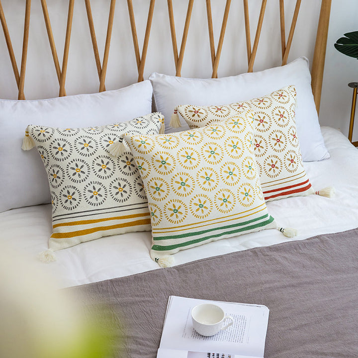 Decorative cushion cover with woven medallion pattern and tassels