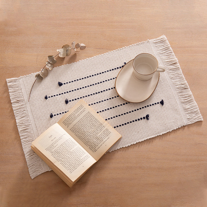 Woven placemats and table runners made of cotton blend with fine dot stripes and knot applications