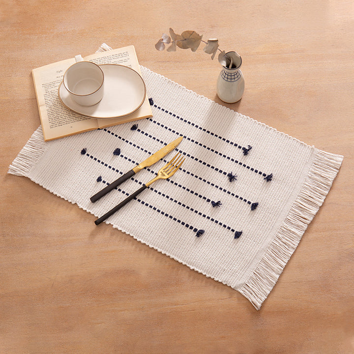 Woven placemats and table runners made of cotton blend with fine dot stripes and knot applications